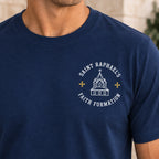 Close-up of the men’s Saint Raphael’s Faith Formation design on the navy T-shirt