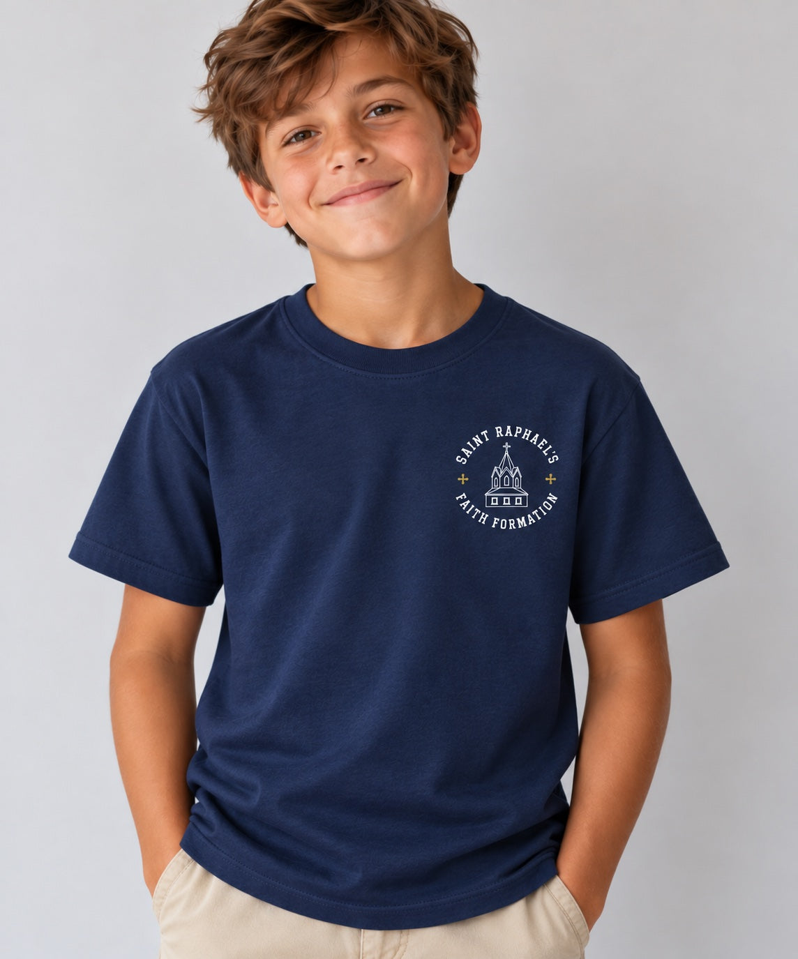 Saint Raphael’s Faith Formation youth T-shirt in navy, worn by a boy