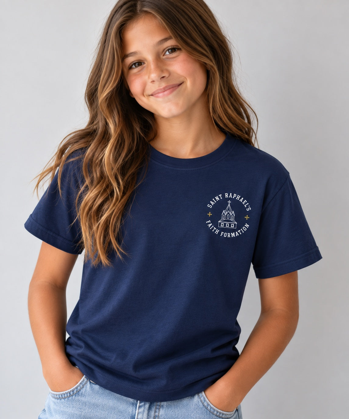 Saint Raphael’s Faith Formation youth T-shirt in navy, worn by a girl