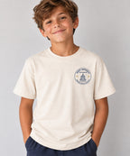 Saint Raphael’s Faith Formation youth T-shirt in cream, worn by a boy