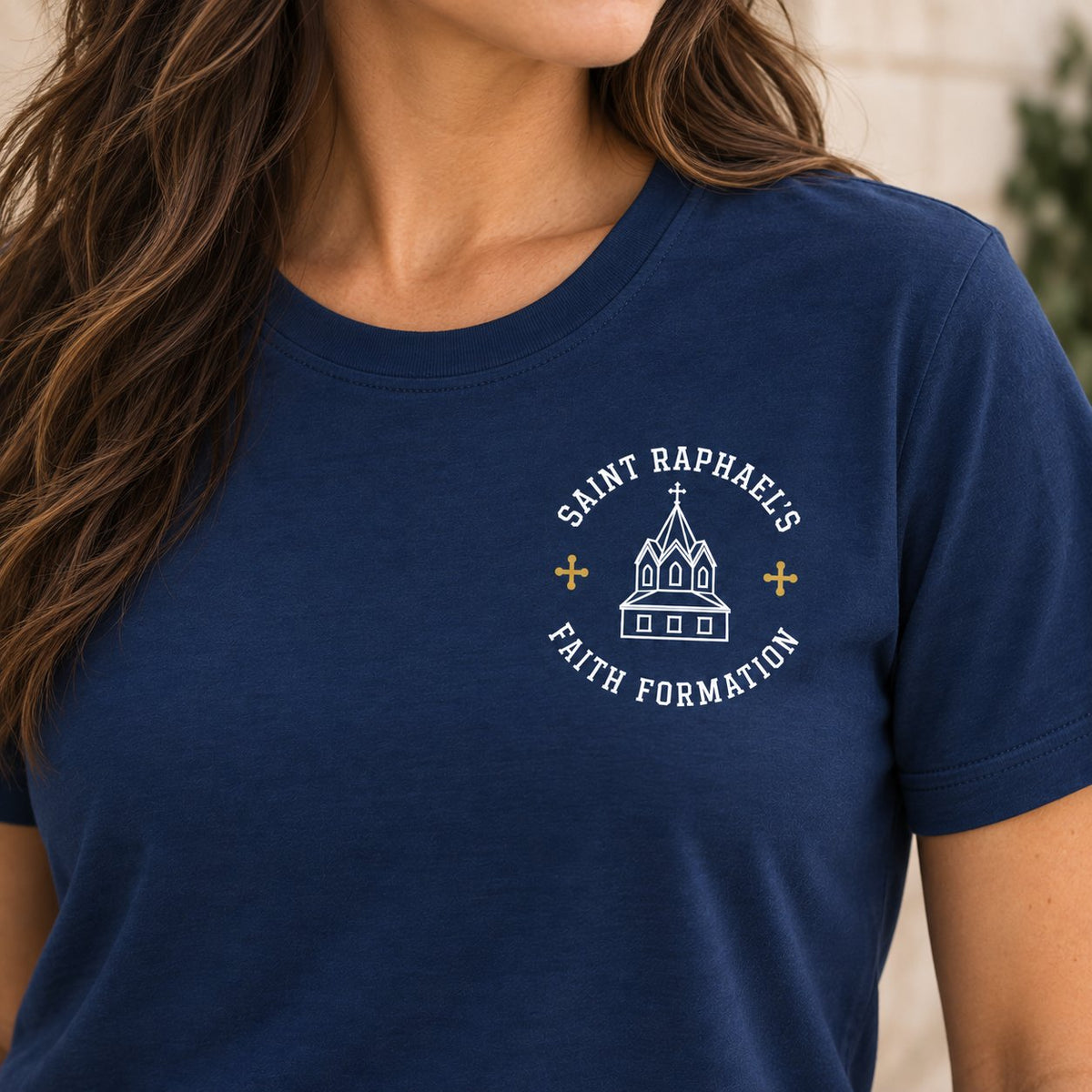 Close-up of the women’s Saint Raphael’s Faith Formation Parish design on the navy T-shirt