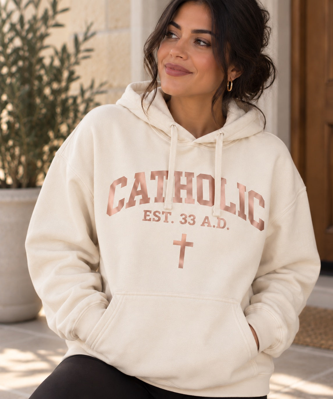 Women’s Catholic Varsity hoodie in natural with rose gold lettering