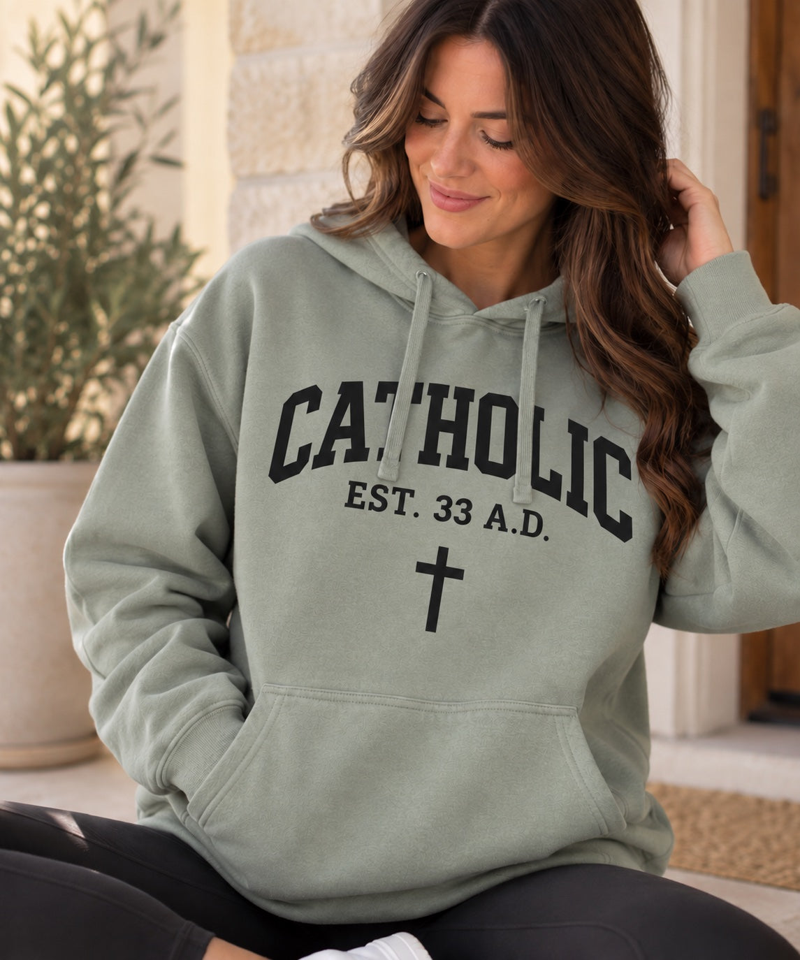 Women’s Catholic Varsity hoodie in sage with black lettering