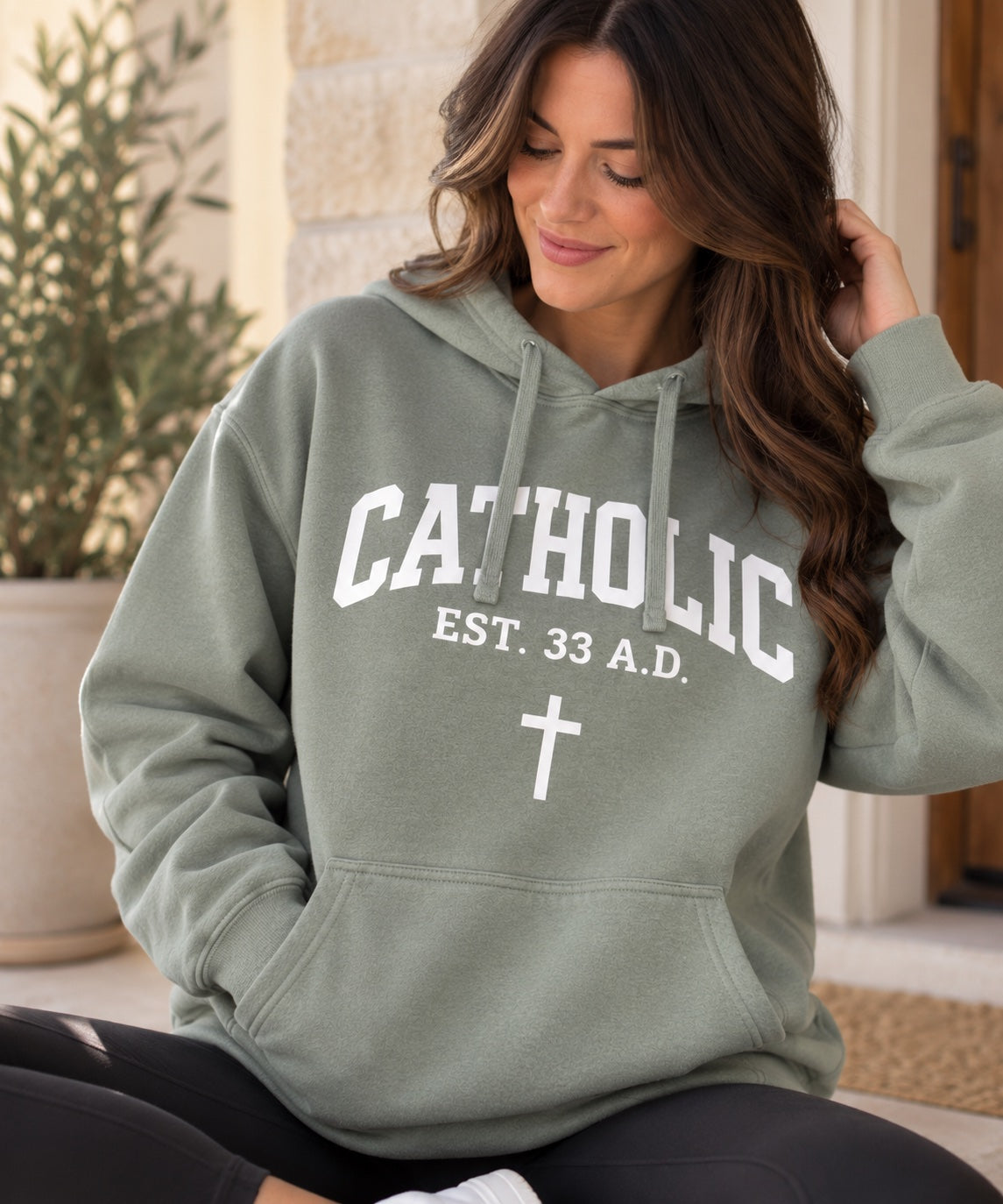 Women’s Catholic Varsity hoodie in sage with white lettering