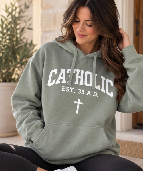 Women’s Catholic Varsity hoodie in sage with white lettering